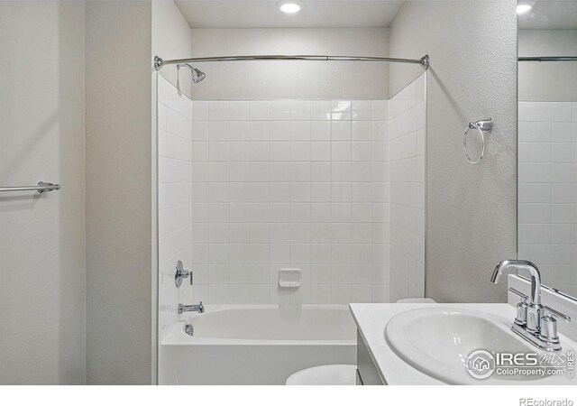 bathroom with toilet, vanity, and shower / washtub combination