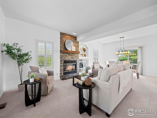 living area featuring a stone fireplace, baseboards, visible vents, and light carpet