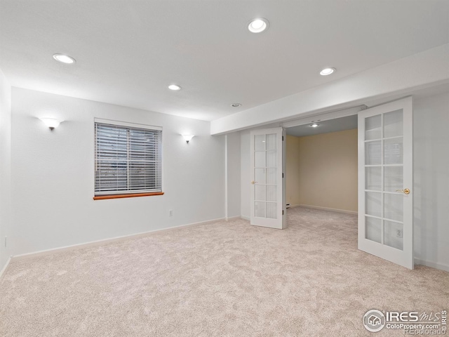 finished below grade area featuring baseboards, french doors, recessed lighting, and carpet