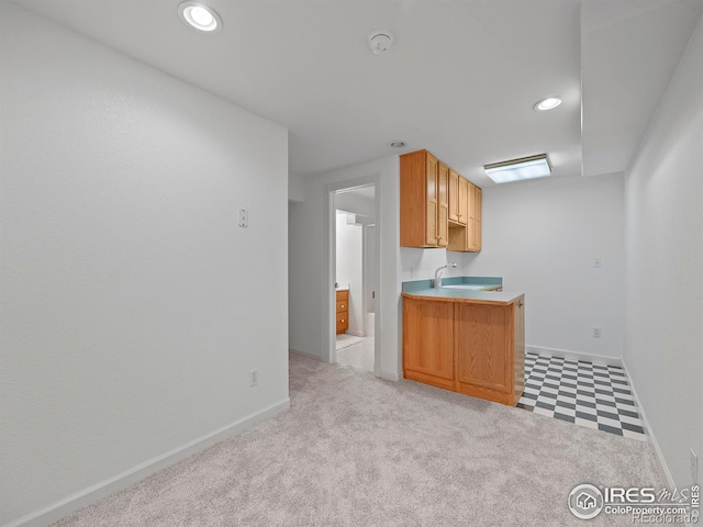 kitchen with light countertops, carpet floors, baseboards, and recessed lighting