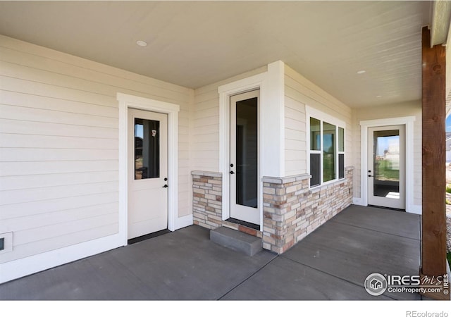 1402 Burt Ave, Berthoud, CO 80513 - property entrance featuring stone siding and a patio area