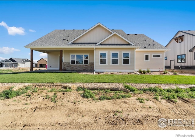 1402 Burt Ave, Berthoud, CO 80513 - back of house featuring board and batten siding, a yard, and a shingled roof