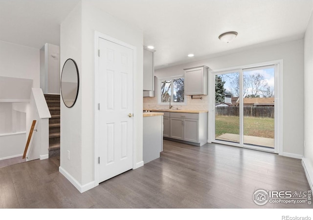 2836 Adobe Dr, Fort Collins, CO 80525 - kitchen featuring light countertops, tasteful backsplash, baseboards, and wood finished floors