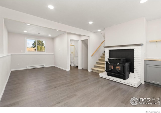 2836 Adobe Dr, Fort Collins, CO 80525 - unfurnished living room featuring wood finished floors, recessed lighting, stairway, and baseboard heating