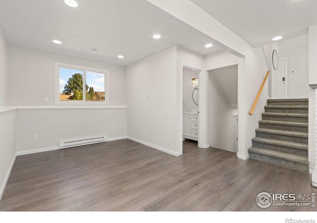2836 Adobe Dr, Fort Collins, CO 80525 - basement with stairs, wood finished floors, baseboard heating, baseboards, and recessed lighting