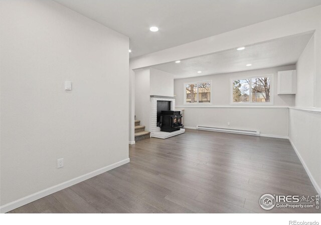 2836 Adobe Dr, Fort Collins, CO 80525 - below grade area featuring baseboards, wood finished floors, recessed lighting, and a baseboard radiator