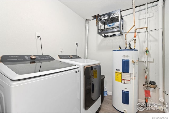 2836 Adobe Dr, Fort Collins, CO 80525 - washroom featuring electric water heater, laundry area, light wood-style floors, and washer and dryer