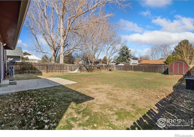 2836 Adobe Dr, Fort Collins, CO 80525 - view of yard featuring a storage unit, a fenced backyard, a patio, and an outbuilding