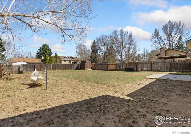 2836 Adobe Dr, Fort Collins, CO 80525 - view of yard featuring a fenced backyard, an outbuilding, and a storage unit
