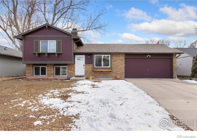 2836 Adobe Dr, Fort Collins, CO 80525 - split level home featuring driveway, brick siding, a chimney, and an attached garage
