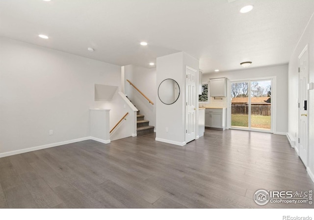 2836 Adobe Dr, Fort Collins, CO 80525 - unfurnished living room featuring baseboards, recessed lighting, and dark wood-style flooring
