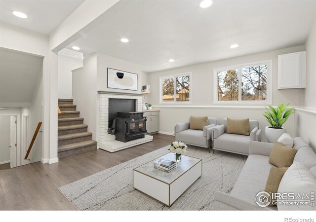 2836 Adobe Dr, Fort Collins, CO 80525 - living room featuring recessed lighting, wood finished floors, a wood stove, and stairway