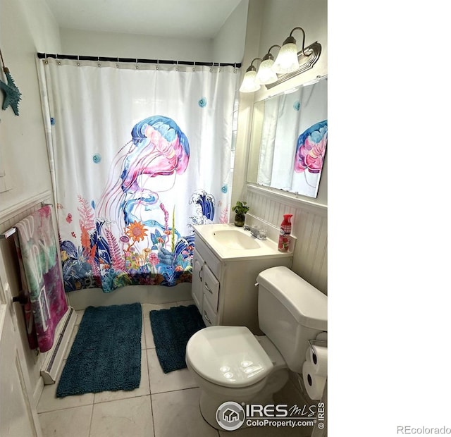 730 Lake St, Fort Morgan, CO 80701 - bathroom with shower / tub combo with curtain, toilet, tile patterned floors, and vanity