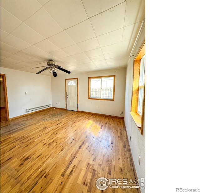 3828 Mckinley Ave, Wellington, CO 80549 - spare room with a ceiling fan, baseboards, a baseboard heating unit, and light wood-type flooring