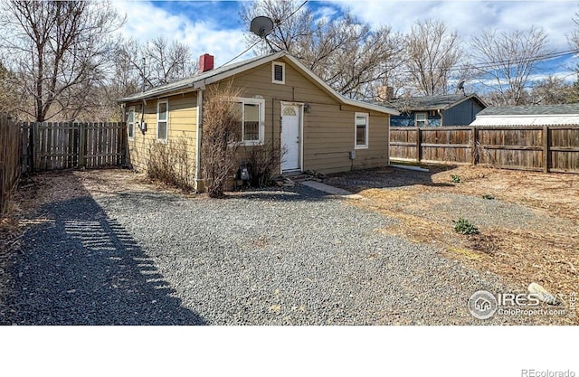 3828 Mckinley Ave, Wellington, CO 80549 - back of house featuring a fenced backyard and a chimney