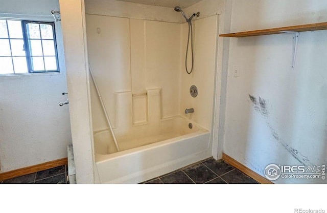 3828 Mckinley Ave, Wellington, CO 80549 - full bath featuring baseboards, tub / shower combination, and tile patterned floors