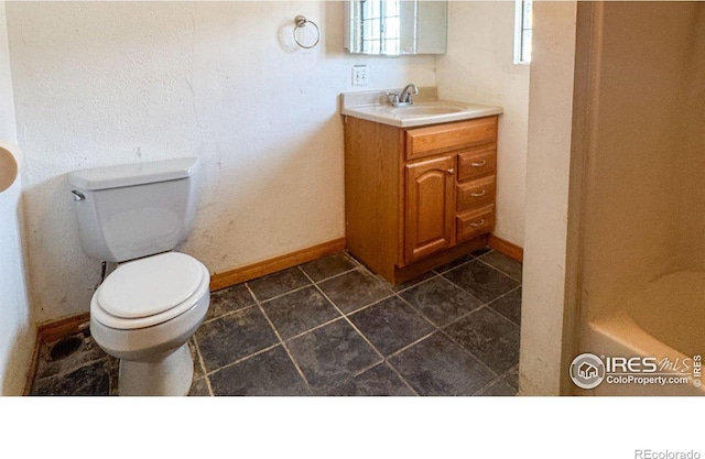 3828 Mckinley Ave, Wellington, CO 80549 - full bath featuring baseboards, toilet, and vanity