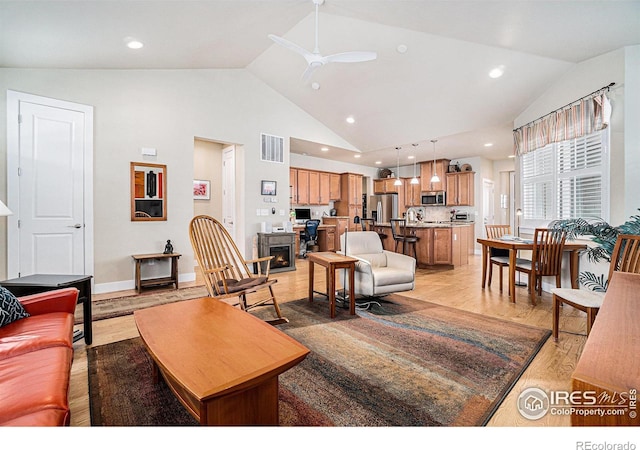 living area with high vaulted ceiling, light wood finished floors, visible vents, ceiling fan, and recessed lighting