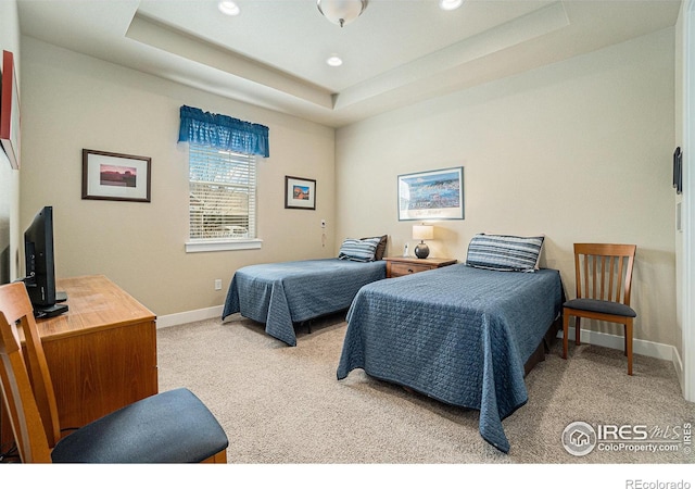 bedroom with baseboards, a tray ceiling, recessed lighting, and light colored carpet