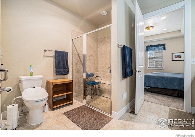 ensuite bathroom featuring toilet, a stall shower, tile patterned flooring, and connected bathroom