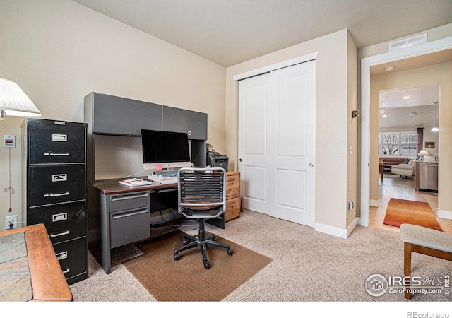 home office featuring light carpet, baseboards, and visible vents