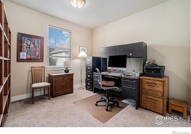 office featuring baseboards, visible vents, and light colored carpet