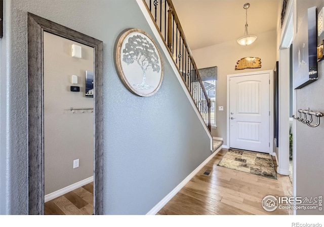 5460 Homeward Dr, Timnath, CO 80547 - entrance foyer with stairway, wood finished floors, and baseboards
