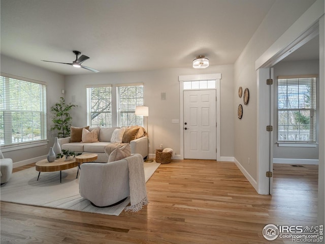 2946 Shoshone Trl, Lafayette, CO 80026 - living area with a ceiling fan, baseboards, visible vents, and light wood-type flooring