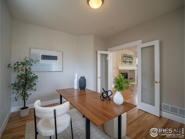 2946 Shoshone Trl, Lafayette, CO 80026 - office space with baseboards, visible vents, french doors, and light wood-style floors