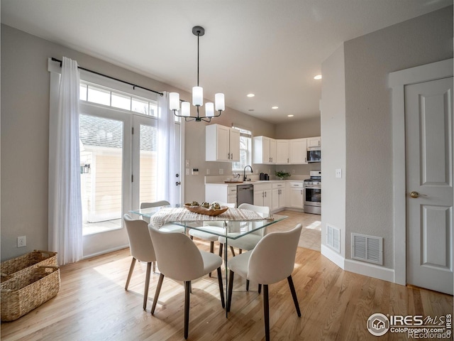 2946 Shoshone Trl, Lafayette, CO 80026 - dining room featuring a chandelier, visible vents, light wood-style flooring, and recessed lighting