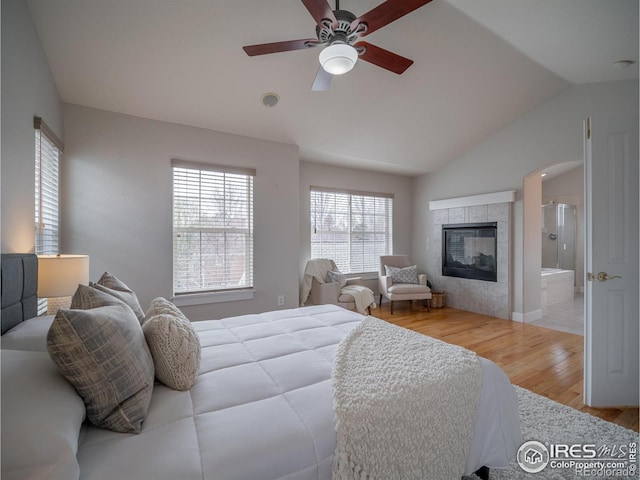 2946 Shoshone Trl, Lafayette, CO 80026 - bedroom with vaulted ceiling, multiple windows, wood finished floors, and a fireplace