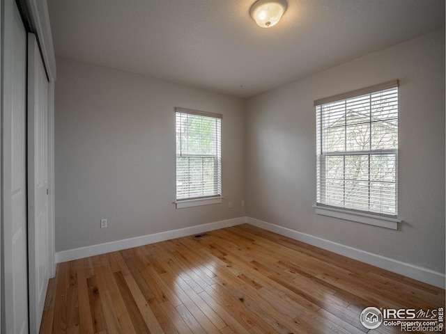 2946 Shoshone Trl, Lafayette, CO 80026 - spare room with baseboards, visible vents, and light wood-style floors