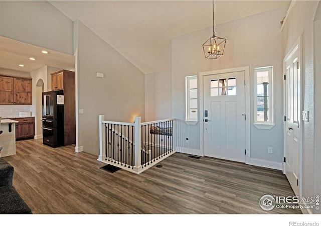 27857 Hopi Trl, Loveland, CO 80534 - foyer featuring recessed lighting, dark wood-style flooring, baseboards, high vaulted ceiling, and a notable chandelier