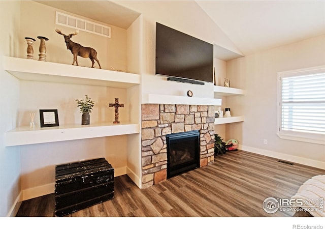 27857 Hopi Trl, Loveland, CO 80534 - living area featuring baseboards, visible vents, lofted ceiling, wood finished floors, and a fireplace