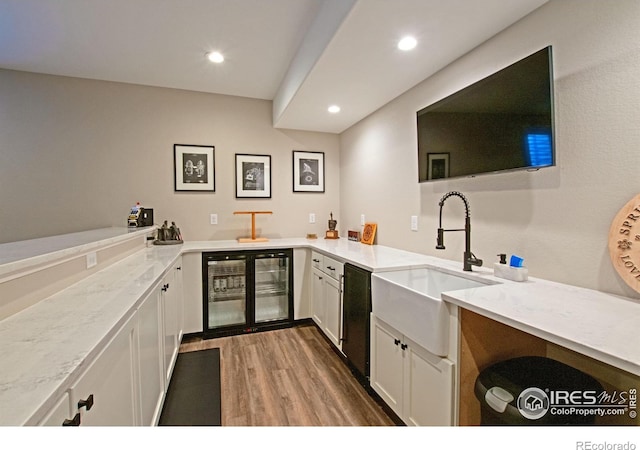 27857 Hopi Trl, Loveland, CO 80534 - bar featuring wood finished floors, a sink, beverage cooler, dishwasher, and recessed lighting