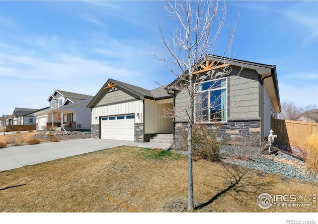 3362 Buffalo Grass Ln, Wellington, CO 80549 - craftsman house featuring stone siding, a garage, driveway, and board and batten siding