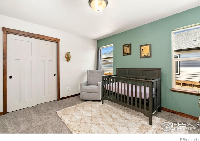 3362 Buffalo Grass Ln, Wellington, CO 80549 - bedroom featuring carpet floors, a closet, baseboards, and a crib