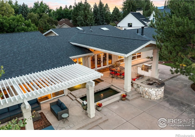 7155 Rustic Trl, Boulder, CO 80301 - back of property at dusk with a shingled roof, a patio, french doors, and an outdoor living space with a fire pit