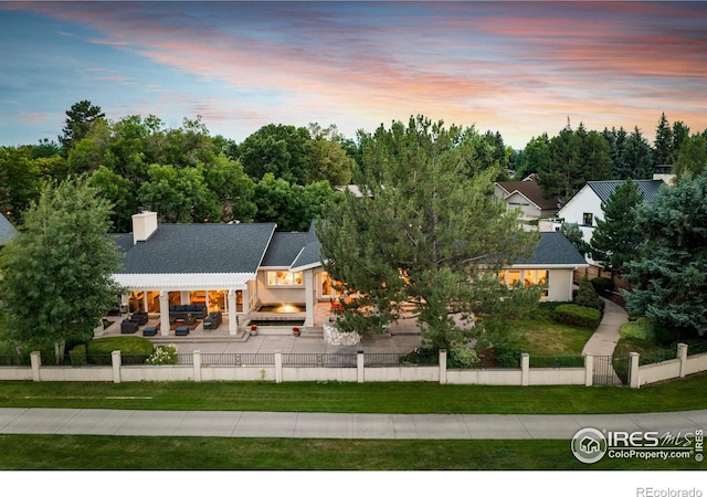 7155 Rustic Trl, Boulder, CO 80301 - back of house with a fenced front yard, a patio, and a chimney