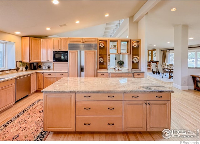 7155 Rustic Trl, Boulder, CO 80301 - kitchen with built in appliances, light wood-style floors, tasteful backsplash, light brown cabinetry, and light stone counters
