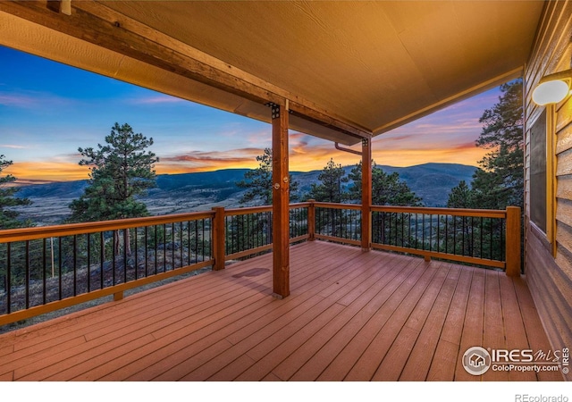 10435 Roan Mountain Rd, Loveland, CO 80538 - deck at dusk featuring a mountain view