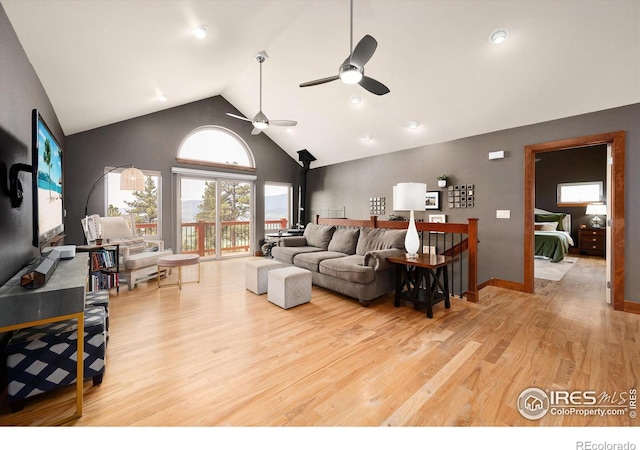 10435 Roan Mountain Rd, Loveland, CO 80538 - living room with baseboards, light wood-type flooring, high vaulted ceiling, and ceiling fan