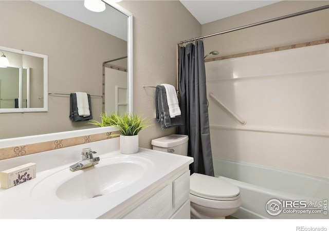 bathroom with toilet, shower / bath combo with shower curtain, and vanity