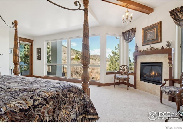 bedroom featuring a tile fireplace, a notable chandelier, carpet floors, visible vents, and baseboards