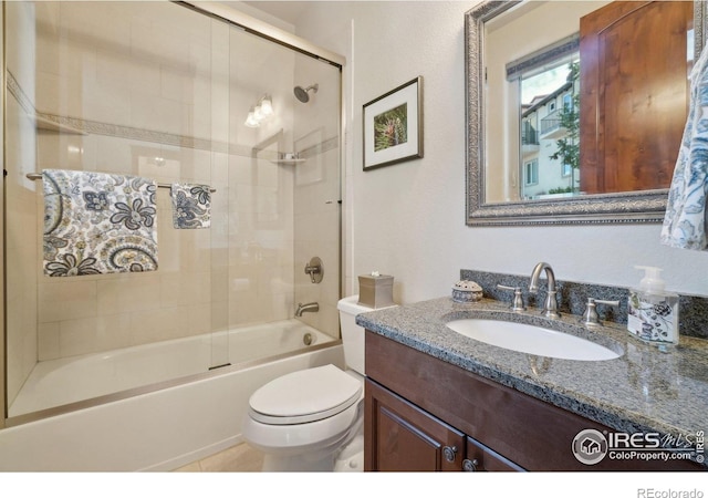 full bathroom with toilet, bath / shower combo with glass door, and vanity