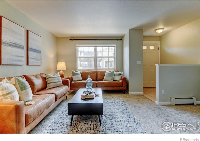 1865 Terry St Unit 3, Longmont, CO 80501 - living area with baseboards, carpet, and a baseboard radiator
