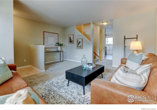 1865 Terry St Unit 3, Longmont, CO 80501 - living room featuring carpet flooring, tile patterned flooring, baseboards, and stairs