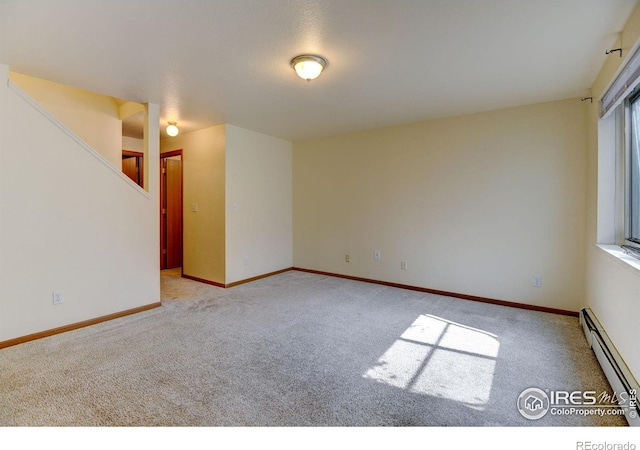1865 Terry St Unit 3, Longmont, CO 80501 - carpeted empty room featuring baseboards, stairway, and baseboard heating