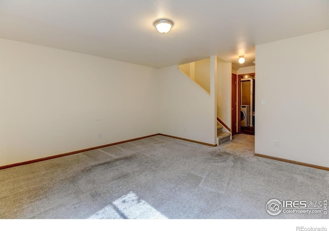 1865 Terry St Unit 3, Longmont, CO 80501 - spare room with baseboards, carpet flooring, stairway, and washer / dryer