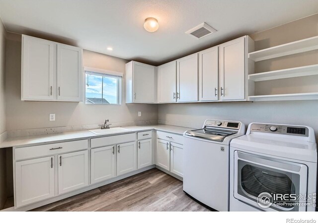 38 Morgan Cir S, Erie, CO 80516 - laundry room with washer and dryer, cabinet space, light wood-style flooring, and recessed lighting